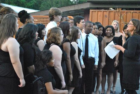 student singers gather outside in formal attire