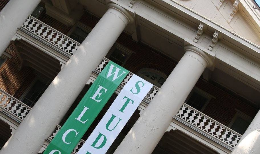 Main Building with 2 green and white folders hanging inscribed "WELCOME" and 'STUDENTS"