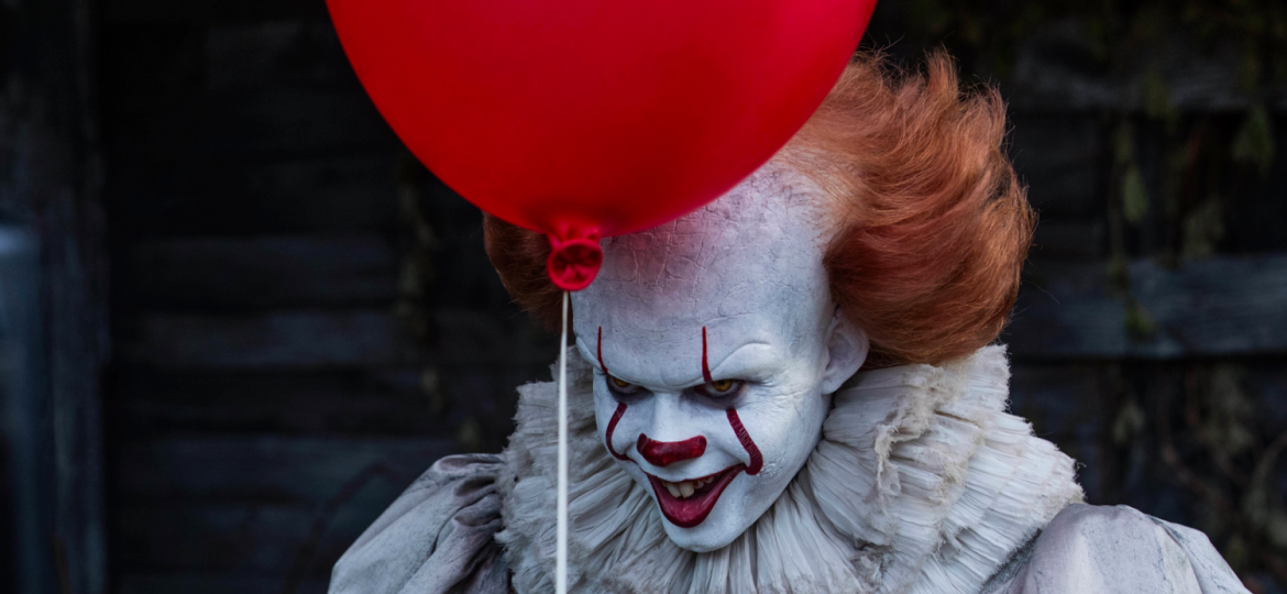 Pennywise the Clown holding a balloon while menacingly staring at the audience