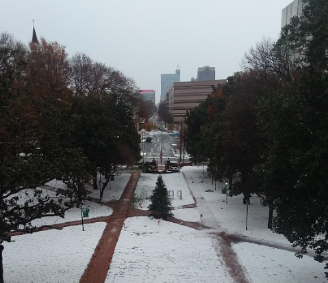 Snow covering main lawn at William Peace University and downtown in the background