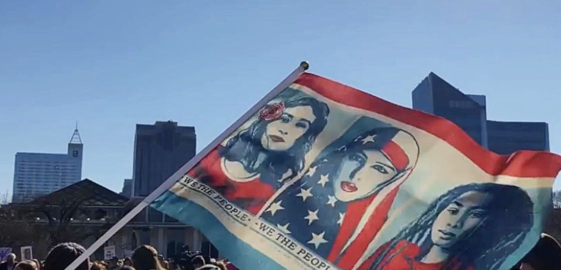 "We the People" flag in the air at the Women's March